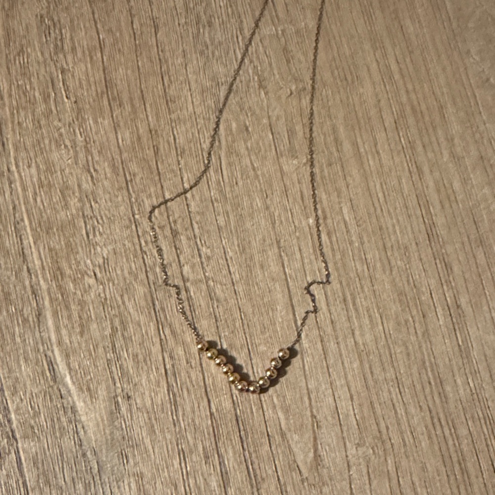 E Newton gold ball necklace